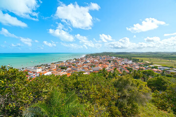 Fototapeta na wymiar Aerial view of Maragogi, AL, Brazil. Landscape of the city and the Maragogi beach, famous tourist destination of the brazilian coast.