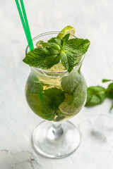 Mojito cocktail with lime and mint in highball glass on dark background vertical image. place for text