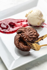 Chocolate fondant with ice cream and strawberry jam, Hot chocolate dessert pudding with liquid center