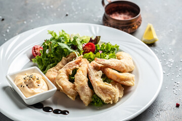 Shrimp fried in batter and sauce with salad. Healthy food, keto diet, diet lunch concept