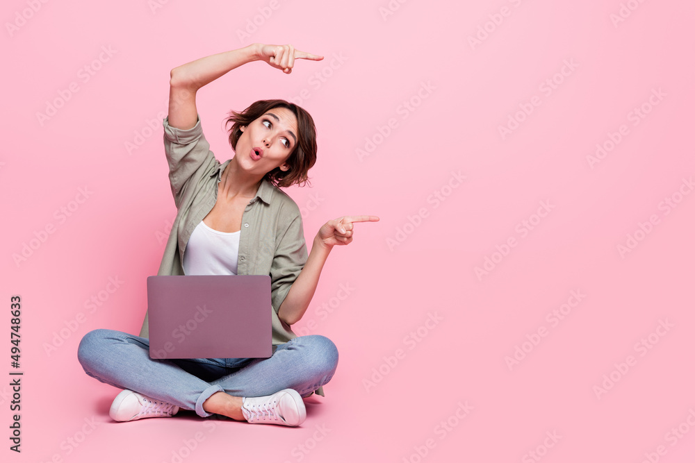 Poster full length photo of astonished lady pouted lips look direct fingers empty space isolated on pink co