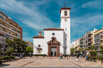 Constitution Square in the center of Fuengirola city with view of the Church "Nuestra Señora del Rosario". Famous plaza in old town center of the city.