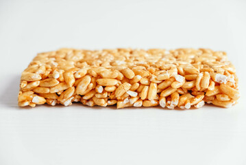 Delicious sweet kozinaki pieces on white wooden table