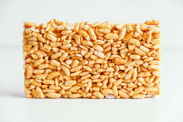 Delicious sweet kozinaki pieces on white wooden table