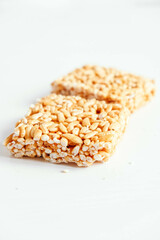 Delicious sweet kozinaki pieces on white wooden table