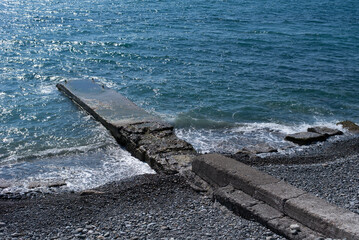 Fototapeta premium shore with the pier of the Black Sea with bright blue water on a clear sunny day