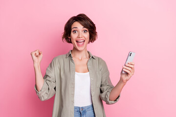 Naklejka premium Photo of rejoice lady use gadget fists up achieve luck network lottery win wear stylish shirt isolated pastel color background