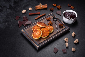 Cottage cheese pancakes, syrniki, ricotta fritters on a wooden cutting board