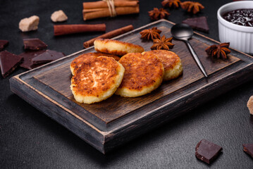 Cottage cheese pancakes, syrniki, ricotta fritters on a wooden cutting board