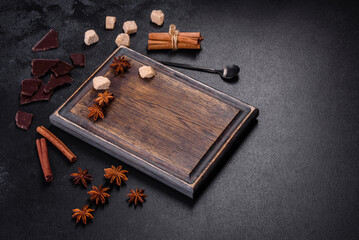 Sugar, cinnamon and other spices on a wooden cutting board