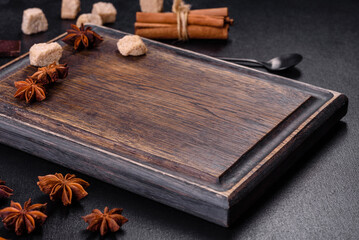 Sugar, cinnamon and other spices on a wooden cutting board