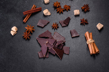 Broken black chocolate pieces with star anise and cinnamon