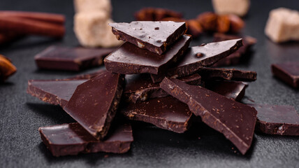 Broken black chocolate pieces with star anise and cinnamon