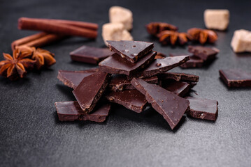 Broken black chocolate pieces with star anise and cinnamon