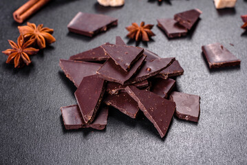 Broken black chocolate pieces with star anise and cinnamon