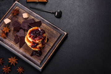 Cottage cheese pancakes, syrniki, ricotta fritters on a wooden cutting board