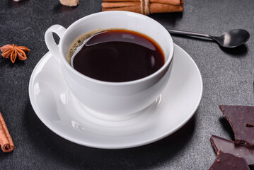 Broken black chocolate pieces with star anise and cinnamon