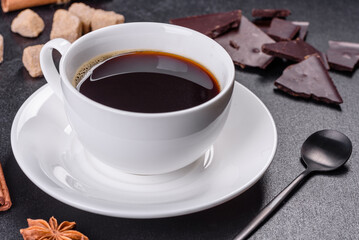 Broken black chocolate pieces with star anise and cinnamon