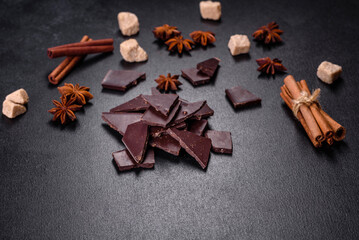 Broken black chocolate pieces with star anise and cinnamon