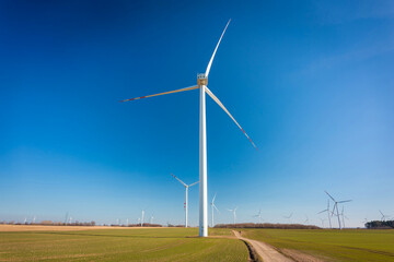 Wind turbines on the meadow over the blue sky