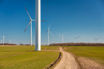 Wind turbines on the meadow over the blue sky