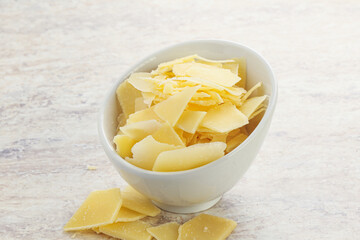 Sliced parmesan cheese heap in the bowl