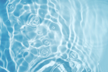 Circles on water. Blue round shadows. Blurred background made with water and light in monochrome. Pureness and freshness concept.