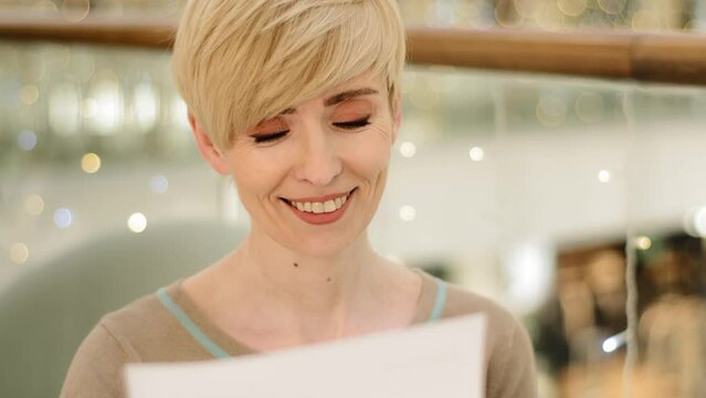 Close Up Caucasian Middle Aged Lady Portrait Woman Adult Female Reading Letter Notice From Bank Note From Family Friend Smiling Happiness Good News Offer Confirmation Financial Notification Invitation