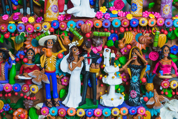 Colorful clay scene of a traditional Mexican wedding with skeletons, part of the ancestral culture...