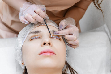 Obraz na płótnie Canvas Eyelash procedure with clinic master and a client in a beauty salon