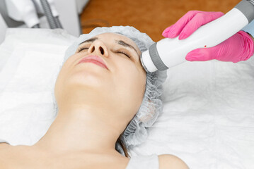 Obraz na płótnie Canvas Radio wave face lifting in a cosmetology clinic photo. Skin treatment. Hardware cosmetology.