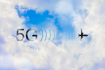 5G signal interference with plane altimeter. Silhouette of flying airplane with text floating over white clouds blue sky. Concept of aviation concerned of high speed internet connection while landing.