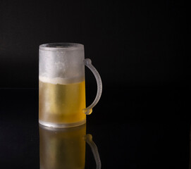 View Mug of cold beer on a black background