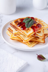Homemade delicious belgian waffles on the white table