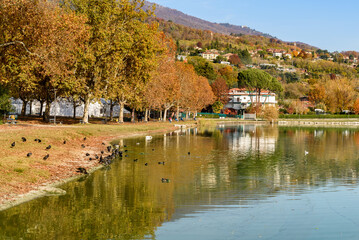 Autumn landscape of Lake Varese with Lakeside promenade in Gavirate, province of Varese, Italy.