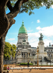 cupula de congreso argentino en dia soleado con arboles y palomas