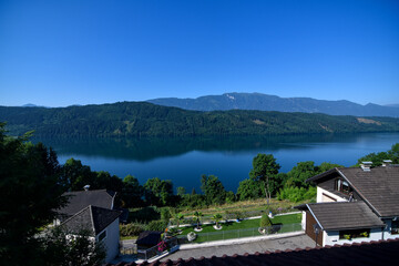 Naklejka premium Lake called Millstätter See in Austria with reflections of the mountains in the water. Alps landscape on a beautiful summer day with a clear and blue sky.