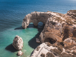 Heart-shaped cliffs on the shore of Atlantic ocean in Algarve, Portugal. Beautiful summer landscape.