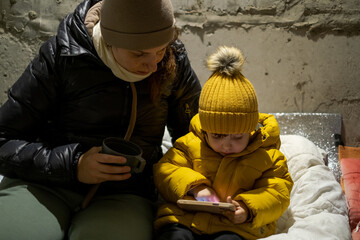 The war between Russia and Ukraine. Children sit in the bomb shelter. Air alarm.