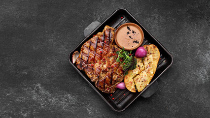 Pork steak with potatoes, spices and sauce