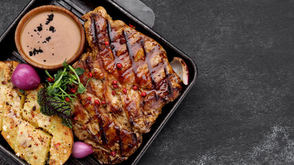 Pork steak with potatoes, spices and sauce