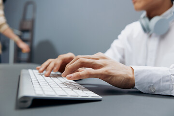 businessmen in headphones hands on keyboard office work close-up technologies