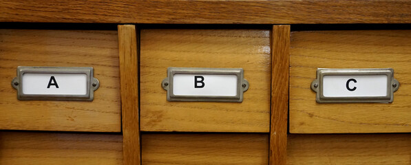 ABC letters as an inscription on a wooden archive cabinet