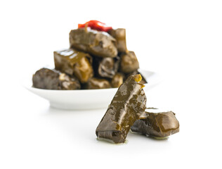 Dolmades. Stuffed vine leaves. Greek appetizer on plate isolated on white background.