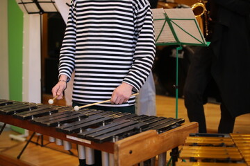 A person with a mallet in his hand playing a musical instrument xylophone at a jazz band training...