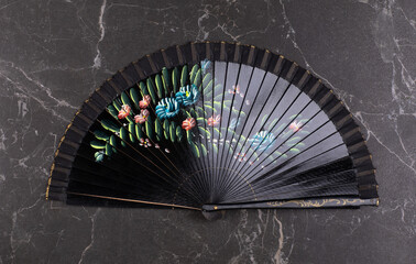 black theatrical fan on a black background