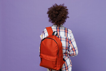 Fototapeta Back rear view of young girl woman of African American ethnicity teen student in shirt backpack isolated on pastel plain purple color background. Education in high school university college concept. obraz