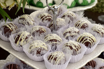 table with decorated and packaged party sweets, chocolate bonbons