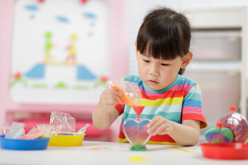 young girl making sand  crafts for homeschooling