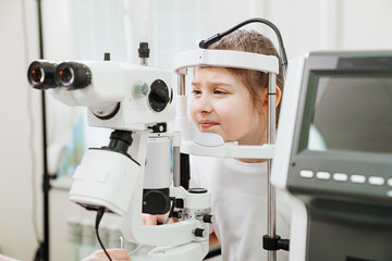examination of girl with slit lamp. equipping ophthalmologist's office.